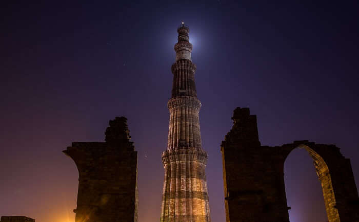 A night photoshoot at Qutub Minar in Delhi, one of the coldest places to visit in winter in India