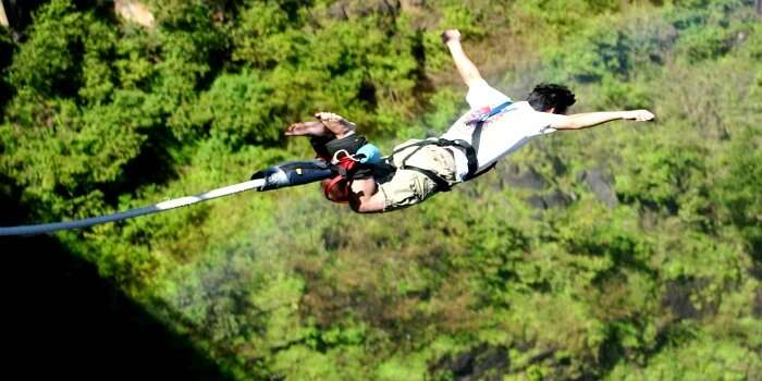 A man tries bungee jumping at a location in India