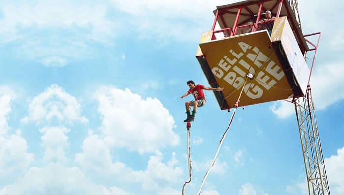 A man jumps of a platoform suspended by crane at Della in Lonavala
