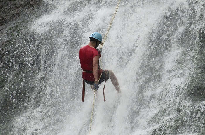 A tourist tries rappelling at waterfalls at Igatpuri