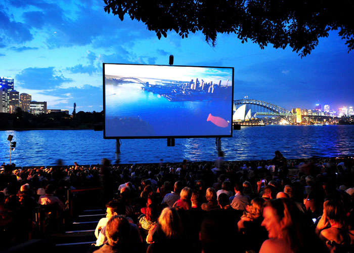 At St George Oper Air Cinema you can watch the screen rise, breaking the water surface, with the Opera House the Harbor Bridge, and the setting sun in the backdrop