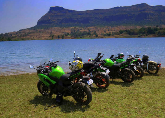 Bikes stand on the banks of the Vaitarna reservoir