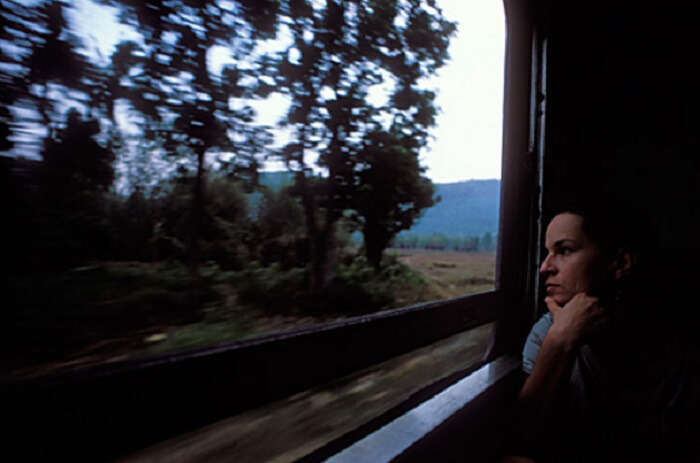 A female traveler looking out of a train window