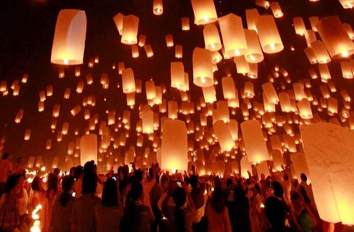 People lighting candles at Full moon party in Thailand