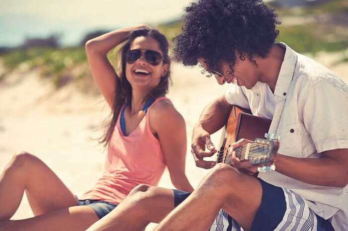 Woman enjoying on a sandy beach with her man