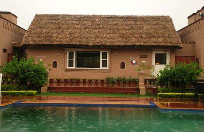 Exterior view of the Hut-K restaurant at Aura Vaseela resort near Chandigarh on a rainy day