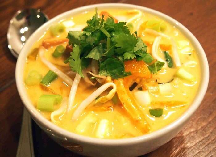 Noodles dipped in natural herbs and creamy curry is a famous food in Singapore