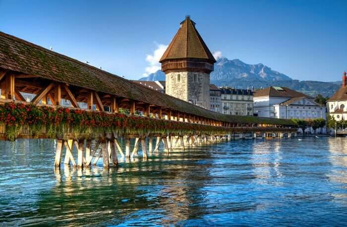 The Chapel Bridge made of wood in Lucerne is one of the major Switzerland tourist attractions