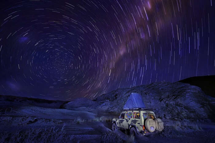 Camping on a jeep top under the gorgeous night sky and stars