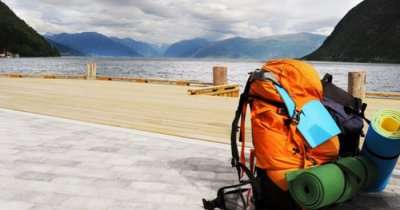 A backpack kept by the side of a water body