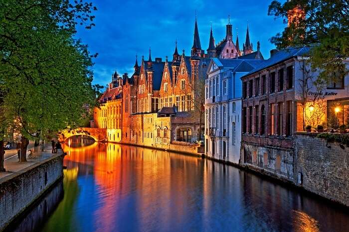 Night shot of historic medieval buildings along a canal in the city of Bruges in Belgium