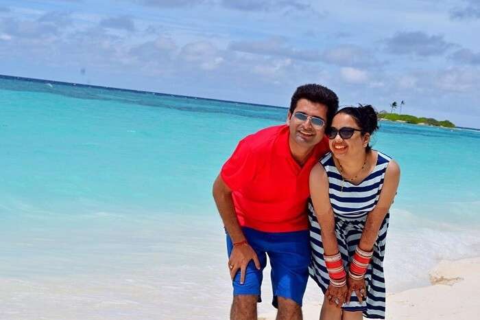 Yatin and his wife pose in front of the beach in Paradise Island and Resort Maldives