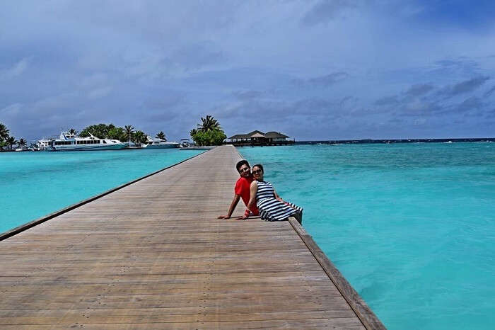 Yatin and wife in the background of the sea in Maldives