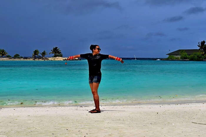 Yatins wife posing on the beach in Maldives