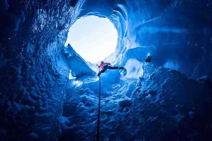 A man climbing an ice formation