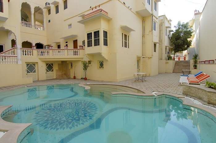 The luxurious pool at Woodsvilla Resort in Jaipur