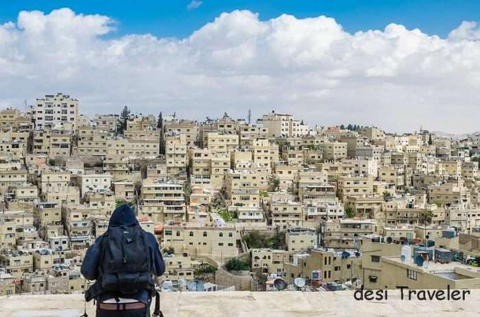 A person in the background of Amman skyline in Jordan