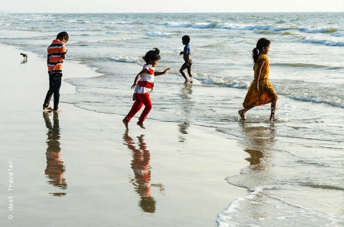 Kids enjoying themselves in the waves of the beaches in Goa