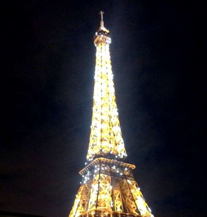 The beautifully lit Eiffel Tower on a clear evening