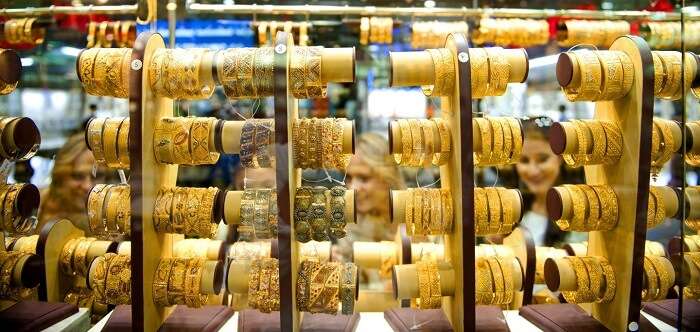 Women trying on different gold jewelry during Dubai Shopping Festival 2016