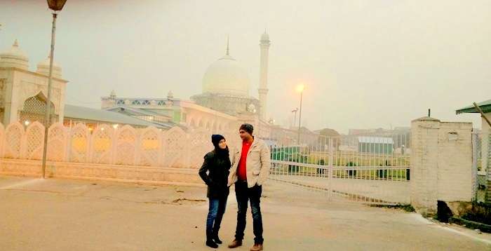 Rachit and his wife outside a Dargah in Srinagar