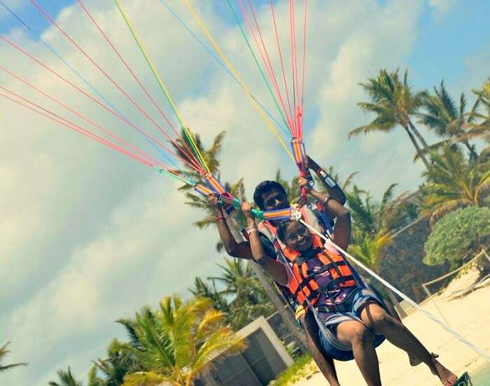 Karthik and his wife do parasailing in Mauritius