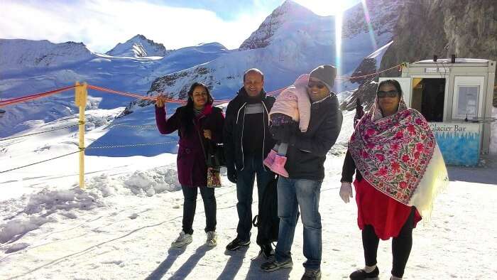 Enjoying a special family moment on top of the snow covered Alps