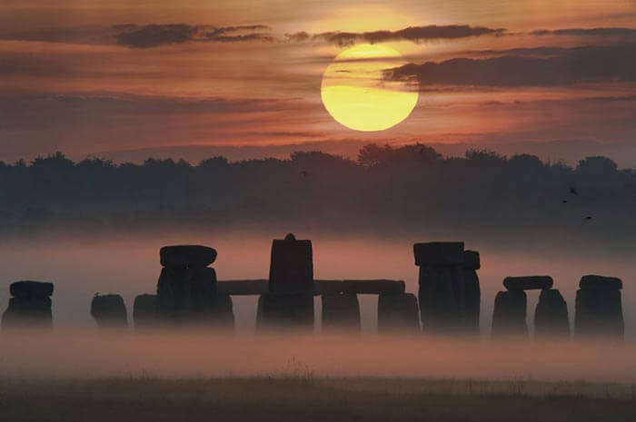 The amazing view of the Stonehenge and the midnight sun over Salisbury