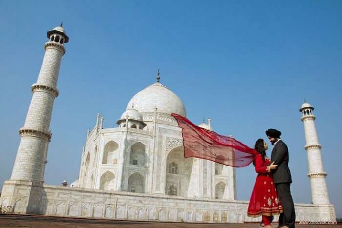 A couple reveling in each other's company at Taj Mahal, one of the best places to go on Valentine's Day