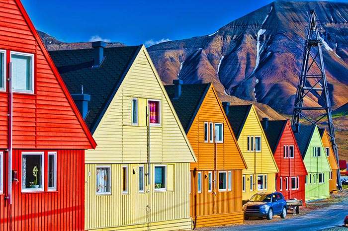 The coloured houses sparkle by the midnight sun in Longyearbyen
