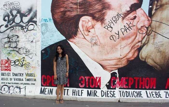 Leena in the background of the Berlin Wall
