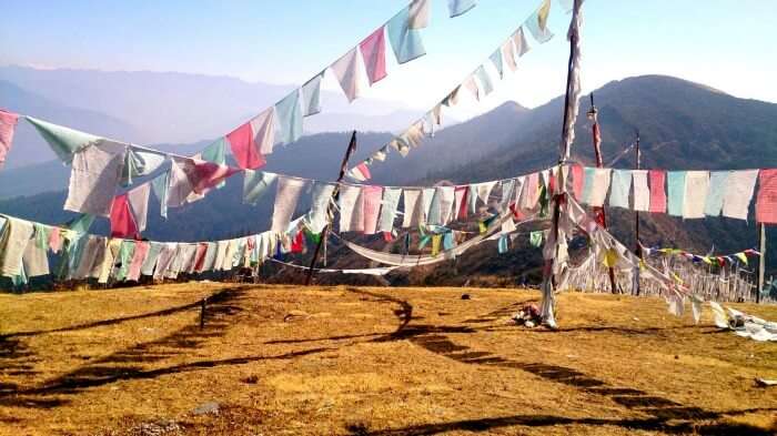 Colourful flags flying across a Bhutan hilltop 