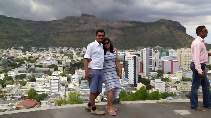 Manuj and his wife pose in the beautiful background of Port Louis