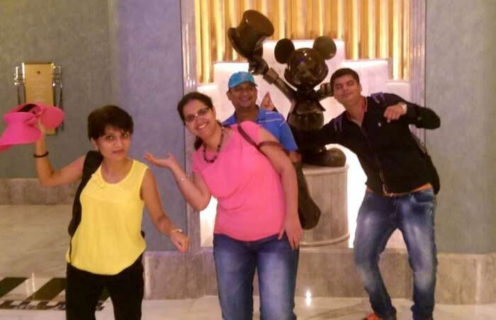 Posing with a Mickey Mouse Statue