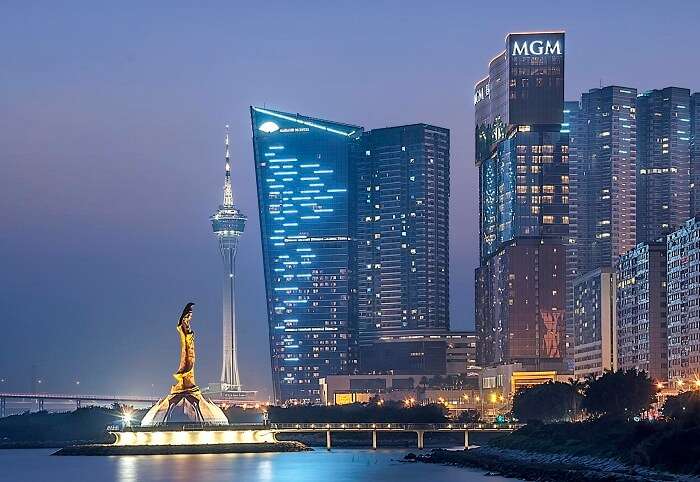 The well-lit view of the bronze statue of Kun Iam in Macau at evening time