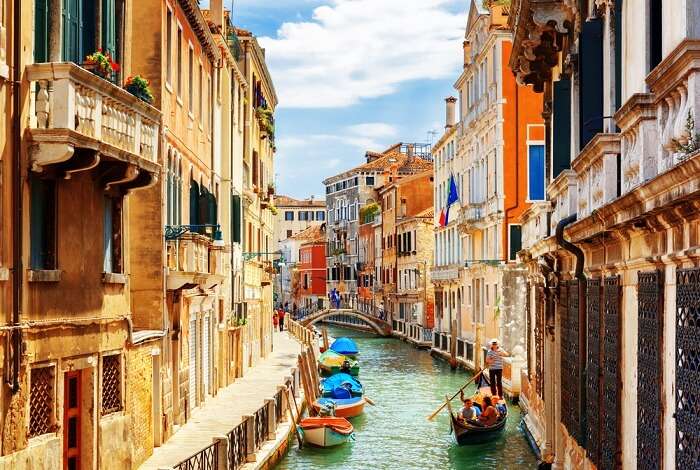 View of the Rio Marin Canal with boats and gondolas from the Ponte de la Bergami in Venice