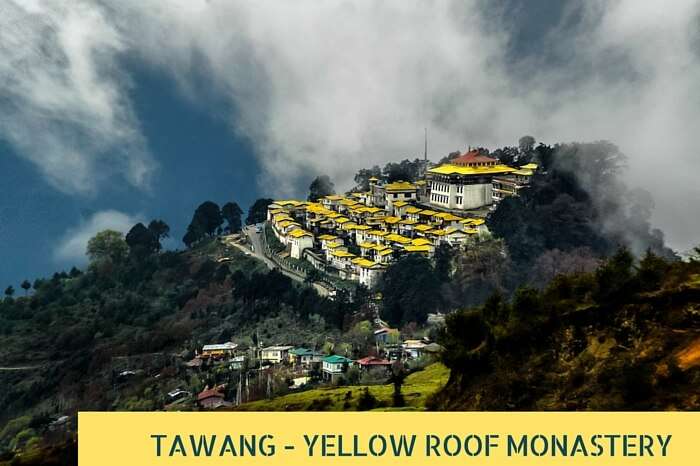 Clouds pass over the yellow roofed monastery at Tawang on an early summer morning