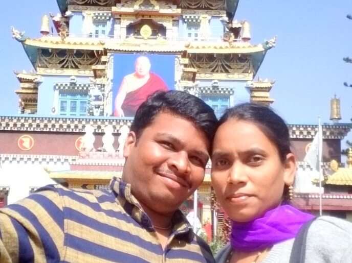 Naveen and his wife click a selfie outside a Tibetan Monastery