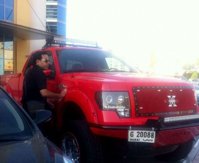 Kapil posing with a truck while on a trip to Dubai