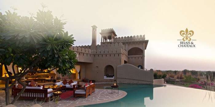 The sitting area by the infinity pool at the Mihir Garh House