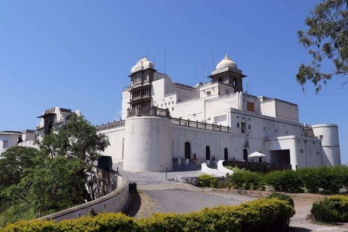 The grand building of Monsoon Palace is perched upon the hills