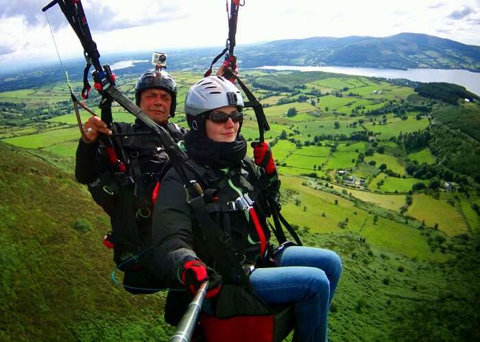 A flyer tries to click a selfie while paragliding in Bir Billing