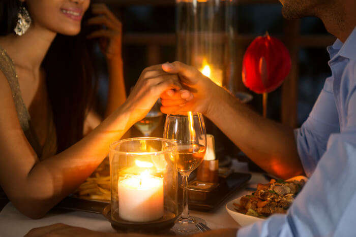 A couple enjoying a romantic meal at a restaurant in Bangalore