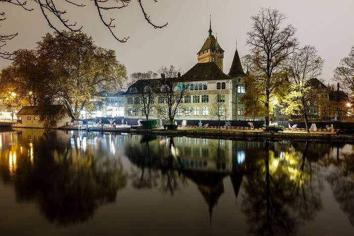 Swiss National Museum and its reflection taken from across the water body