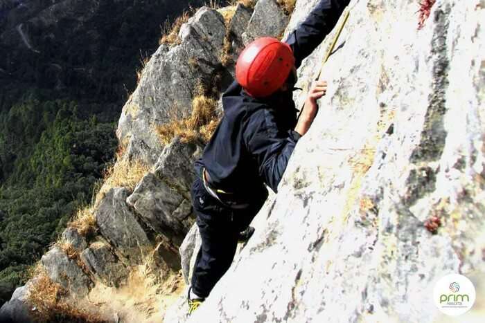 A participant climbing the rocks in Mussoorie