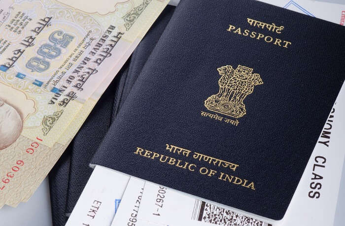 Picture of Indian passport, boarding pass and currency