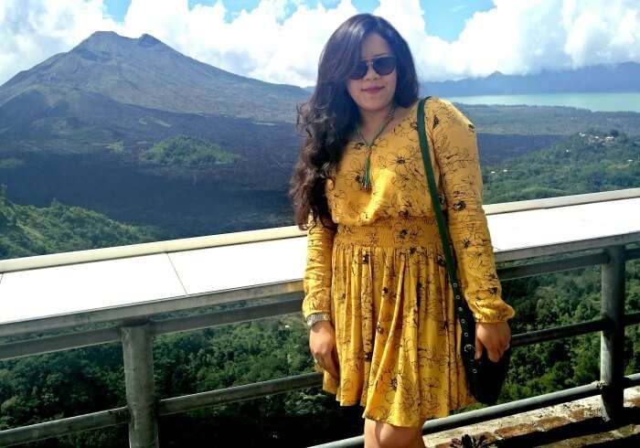 Ritika poses in Bali with Volcano in her background