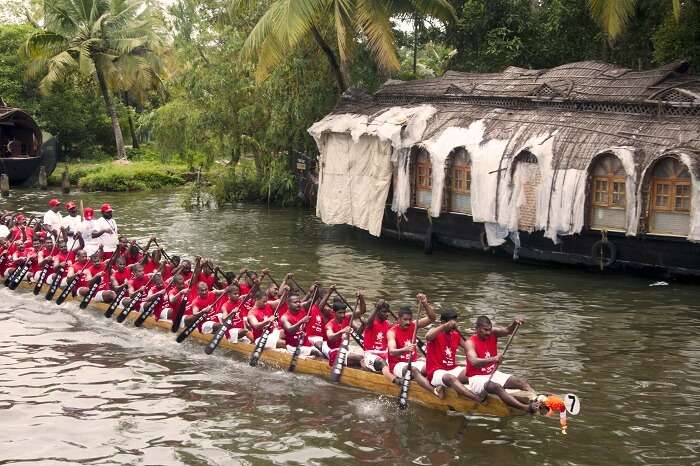 Group of men from Kerala drive a snake boat at the annual boat race event in the Vembanad Lake