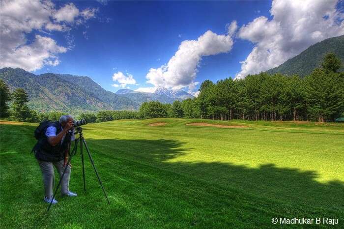 A photographer gets ready to take a snapshot at the Gulmarg Golf Course