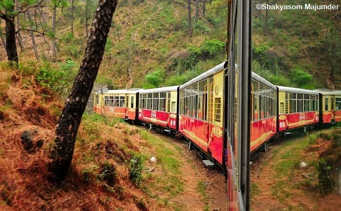 Reflection of the toy train between Shimla and Kalka on the window glass
